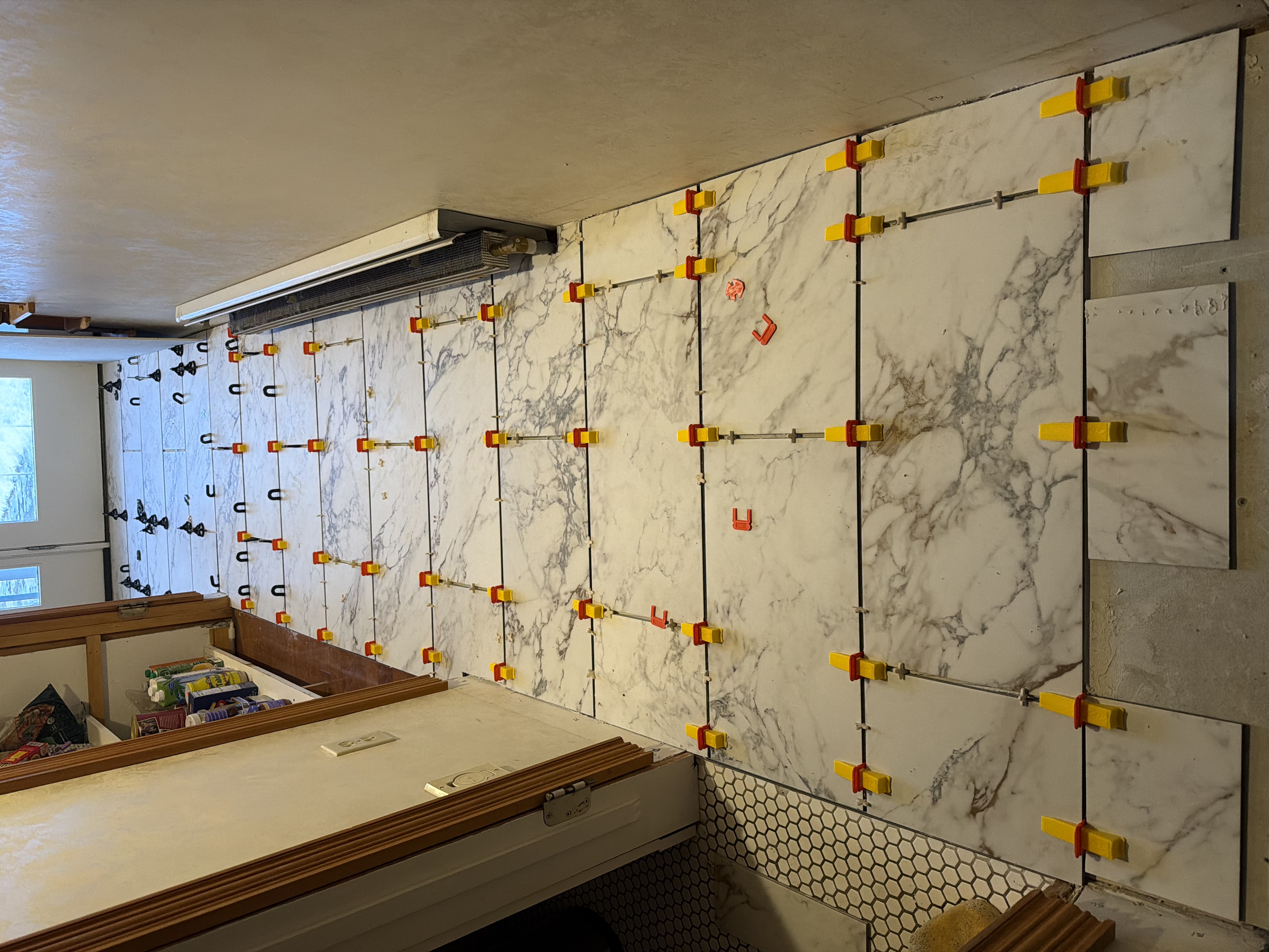 Large format marble tile installation in progress NH